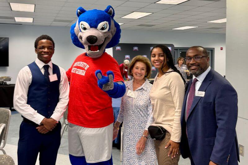 L to R: Cameron Worthy, UWG recipient of the Phil McDowell Memorial Scholarship; Wolfie; Trudy McDowell; Kaitlin Harris, UWG recipient of the Debbie Forrester Memorial Scholarship; and Dr. Christopher Johnson, dean of UWG's Richards College of Business