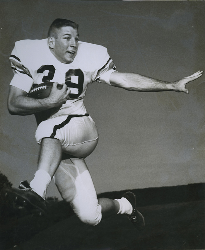 A young Dr. Joseph “Harrison” McCraw Jr. playing footballl