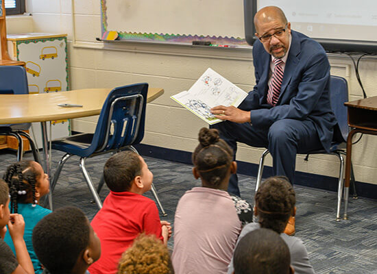 Trent North reads to school children