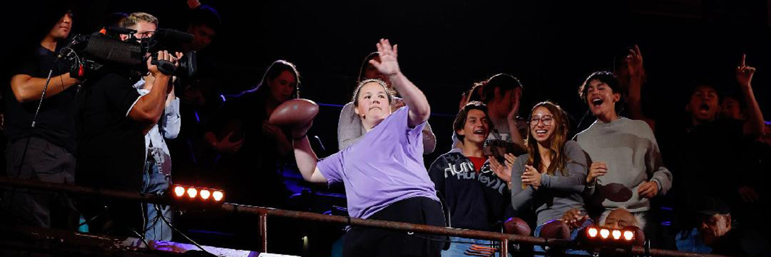 Amanda Badertscher throws football in crowd of America's Got Talent