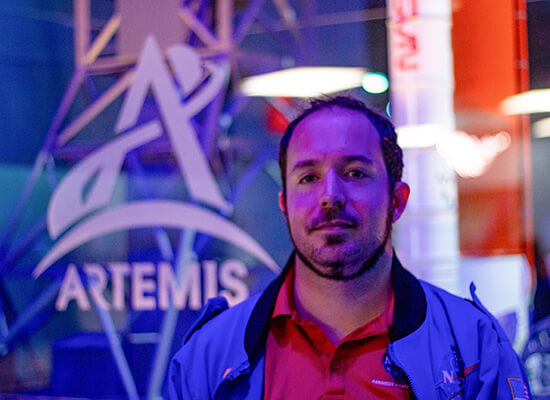 UWG Alumnus Roger Lascorz in front of NASA's Artemis