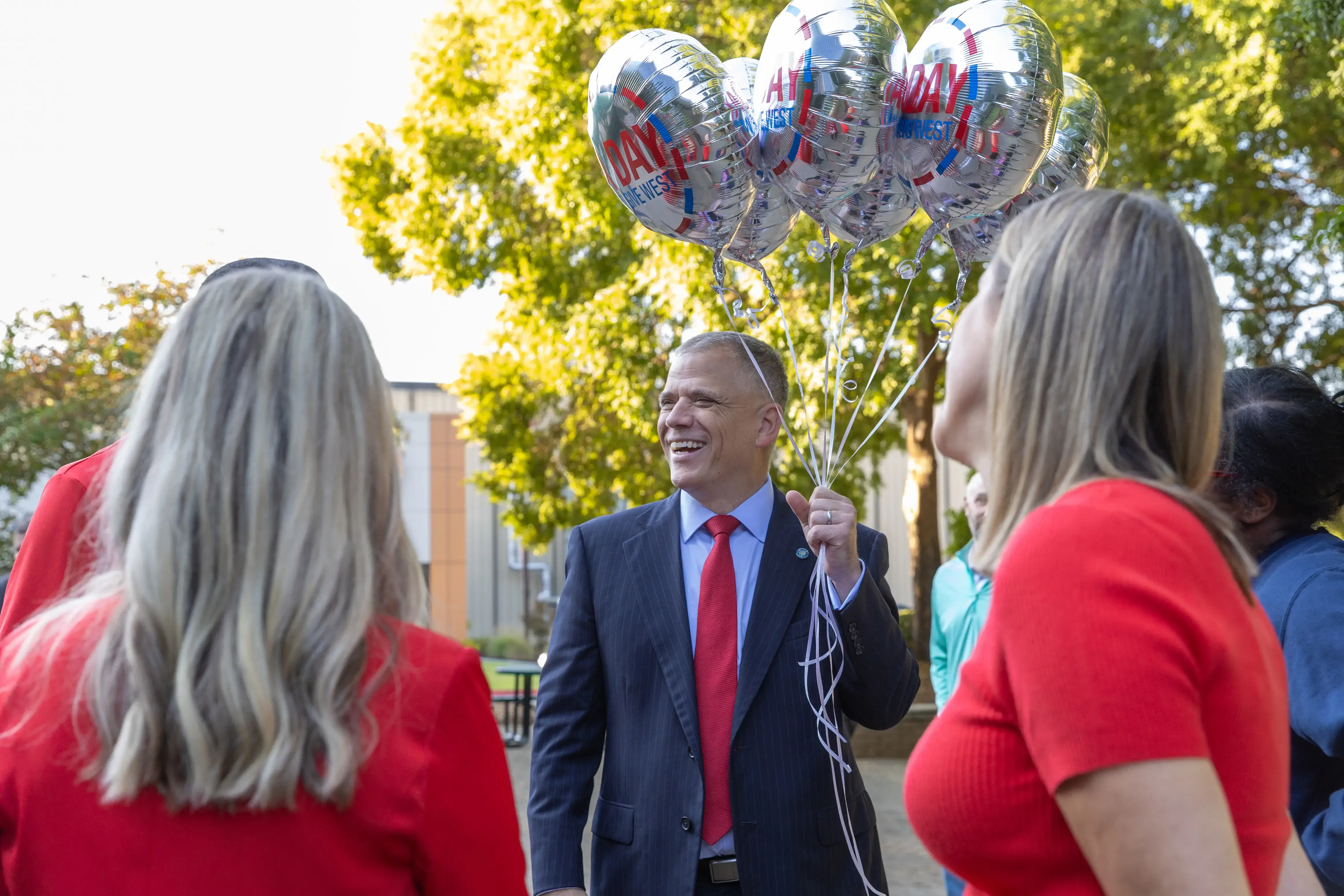 UWG President Dr. Michael Johnson holding A Day balloons