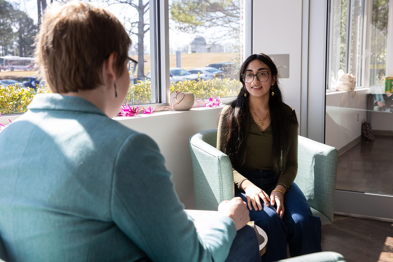Faculty member talking to a UWG student