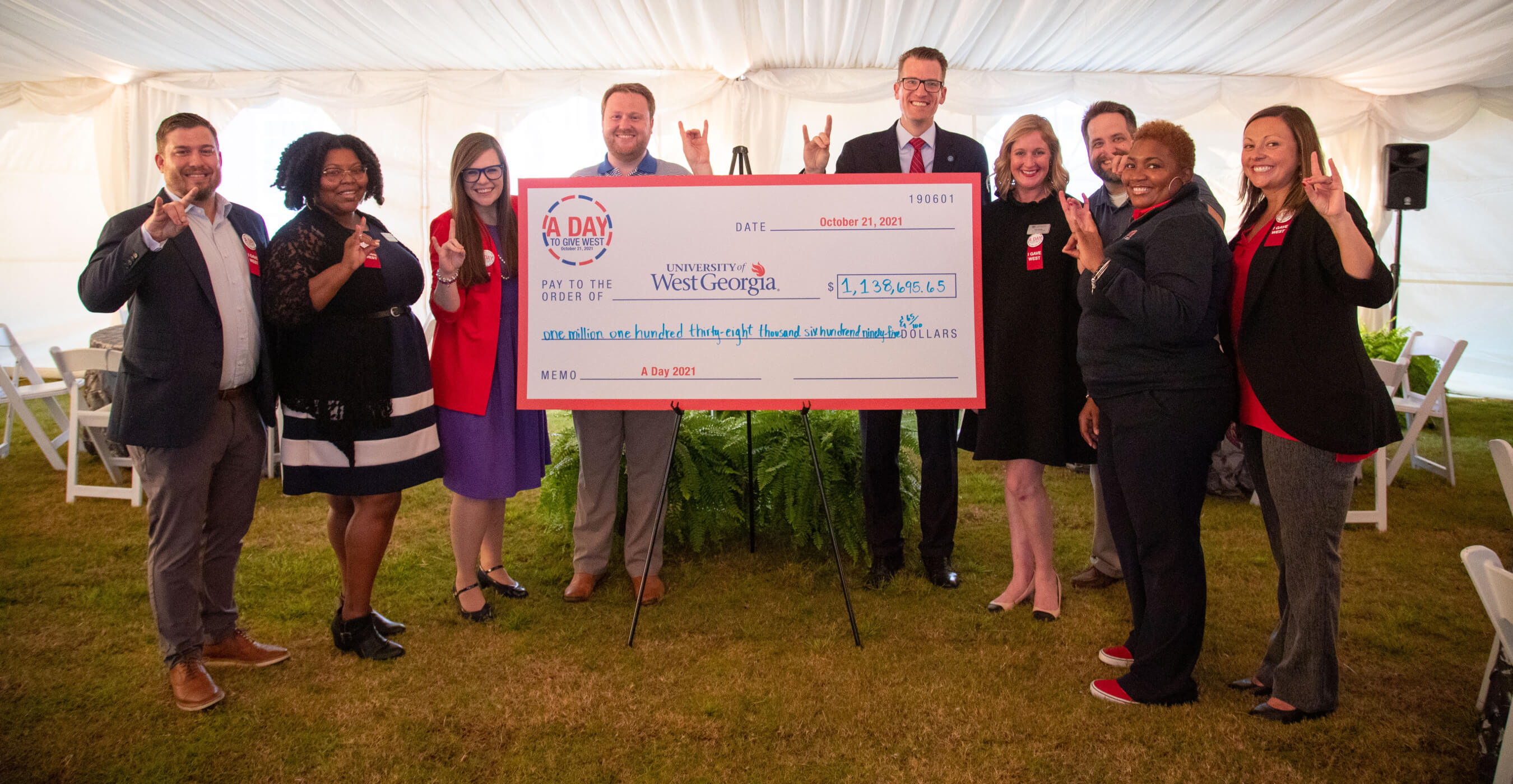 A Day group with giant check