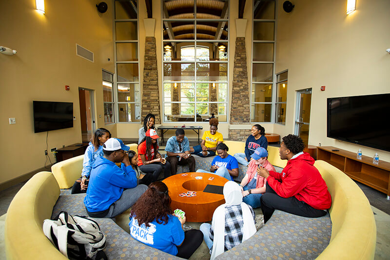UWG students sitting around a table playing cards