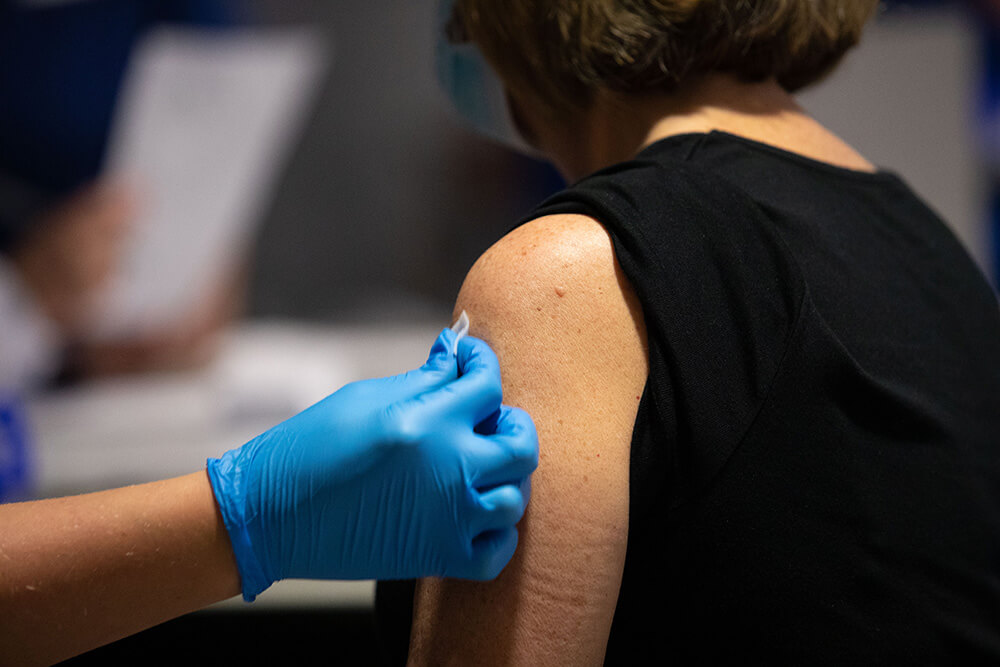 A woman receiving a COVID-19 vaccination