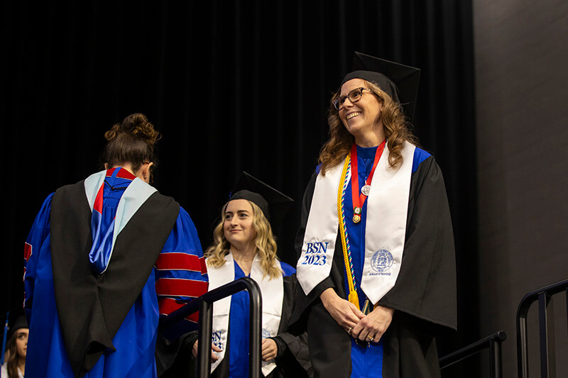UWG graduate walking across the stage at UWG's Fall 2023 Commencement ceremonies