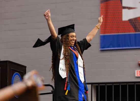 A graduate celebrates at UWG's Fall Commencement