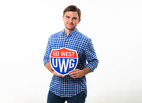 UWG's Witt Teem holding a Go West UWG sign