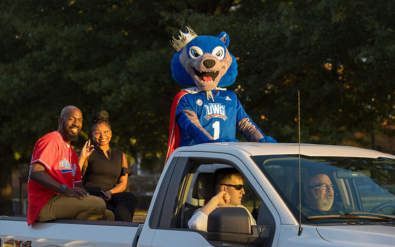 UWG mascot Wolfie rides in back of truck at the Homecoming parade