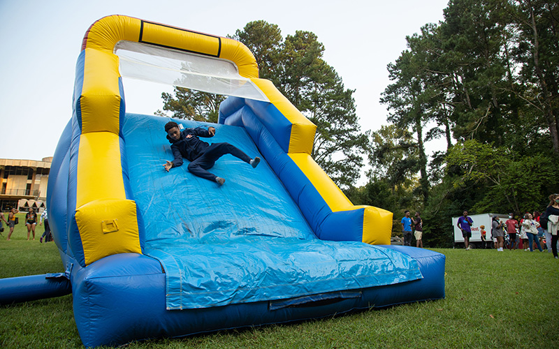 person sliding down an inflated slide