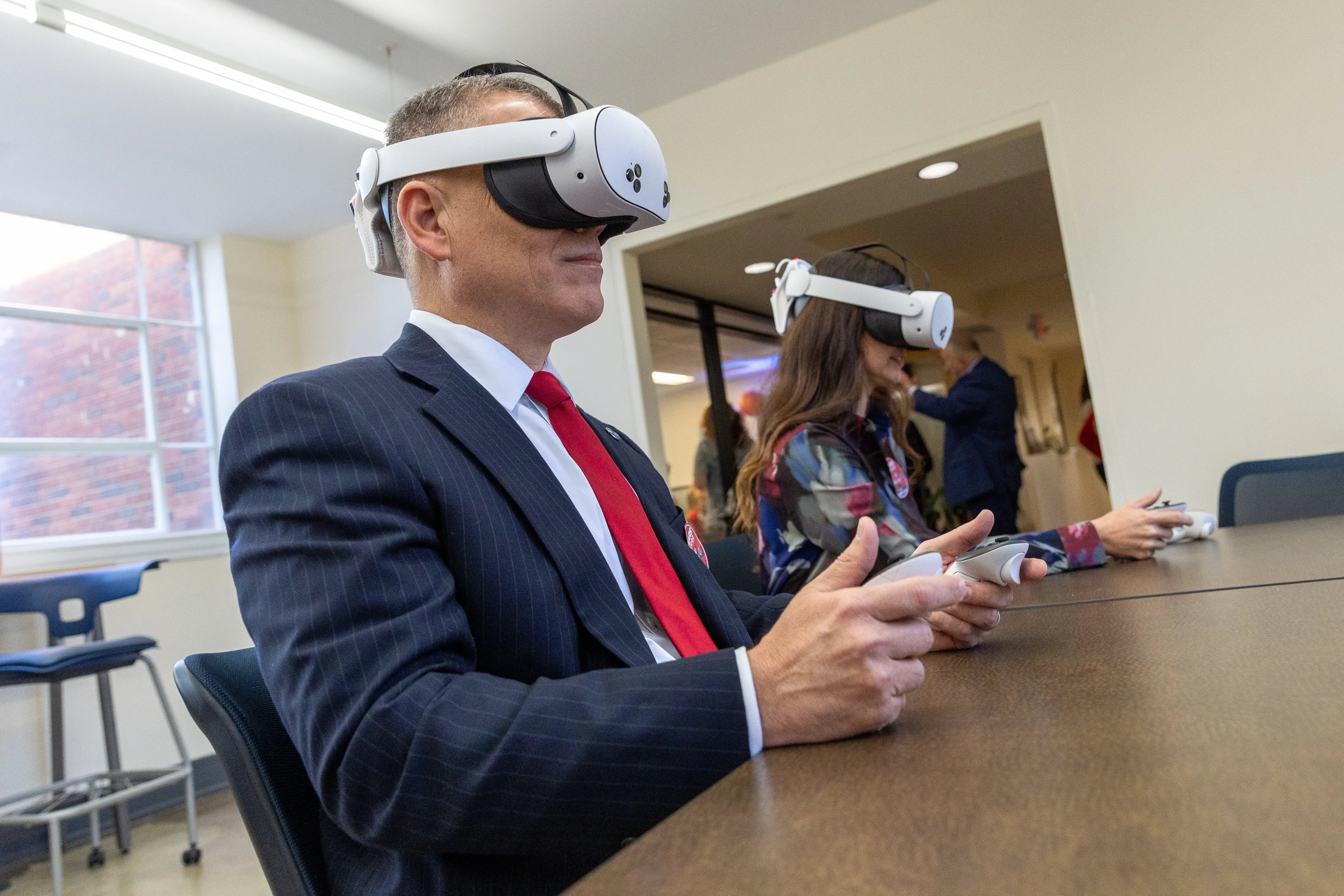 Dr. Michael and Beth Johnson at Innovation in Orbit wearing VR glasses