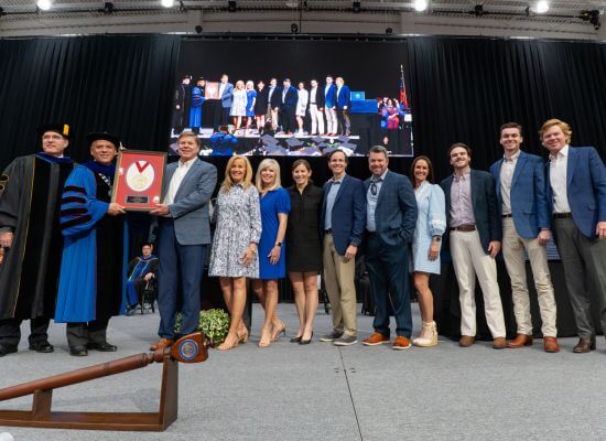 Members of the Stone family accept the inaugural President's Medallion