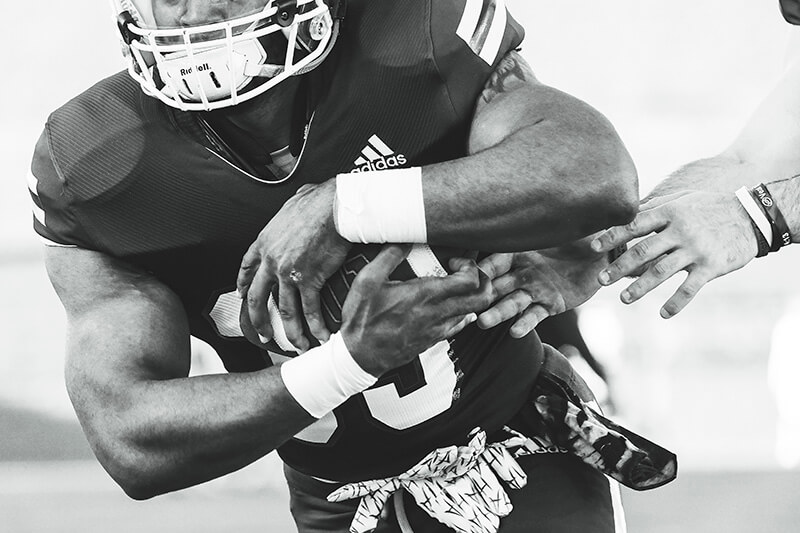 closeup of UWG Wolves football player holding a football