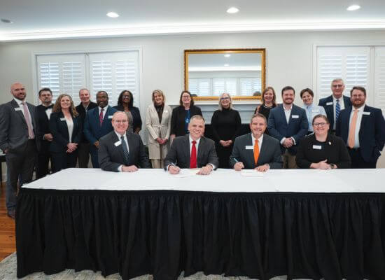 Dr. Michael Johnson, UWG president (bottom middle left), and Dr. Mike Hobbs, GHC president (bottom middle right), signed the agreement surrounded by leaders from both institutions.