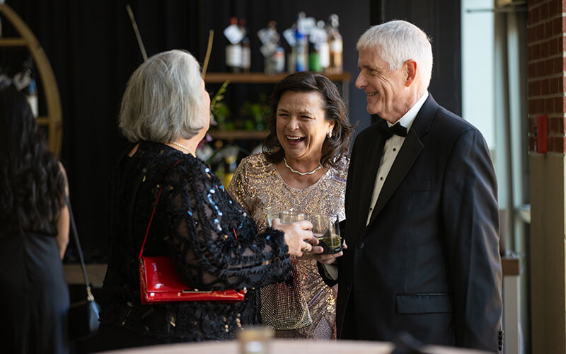 Celebrants laughing at UWG's Presidential Black Tie Gala