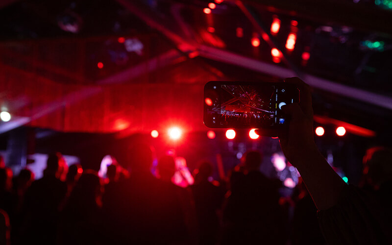 A celebrant holds up a cellphone to capture the festivities at UWG's Presidential Black Tie Gala