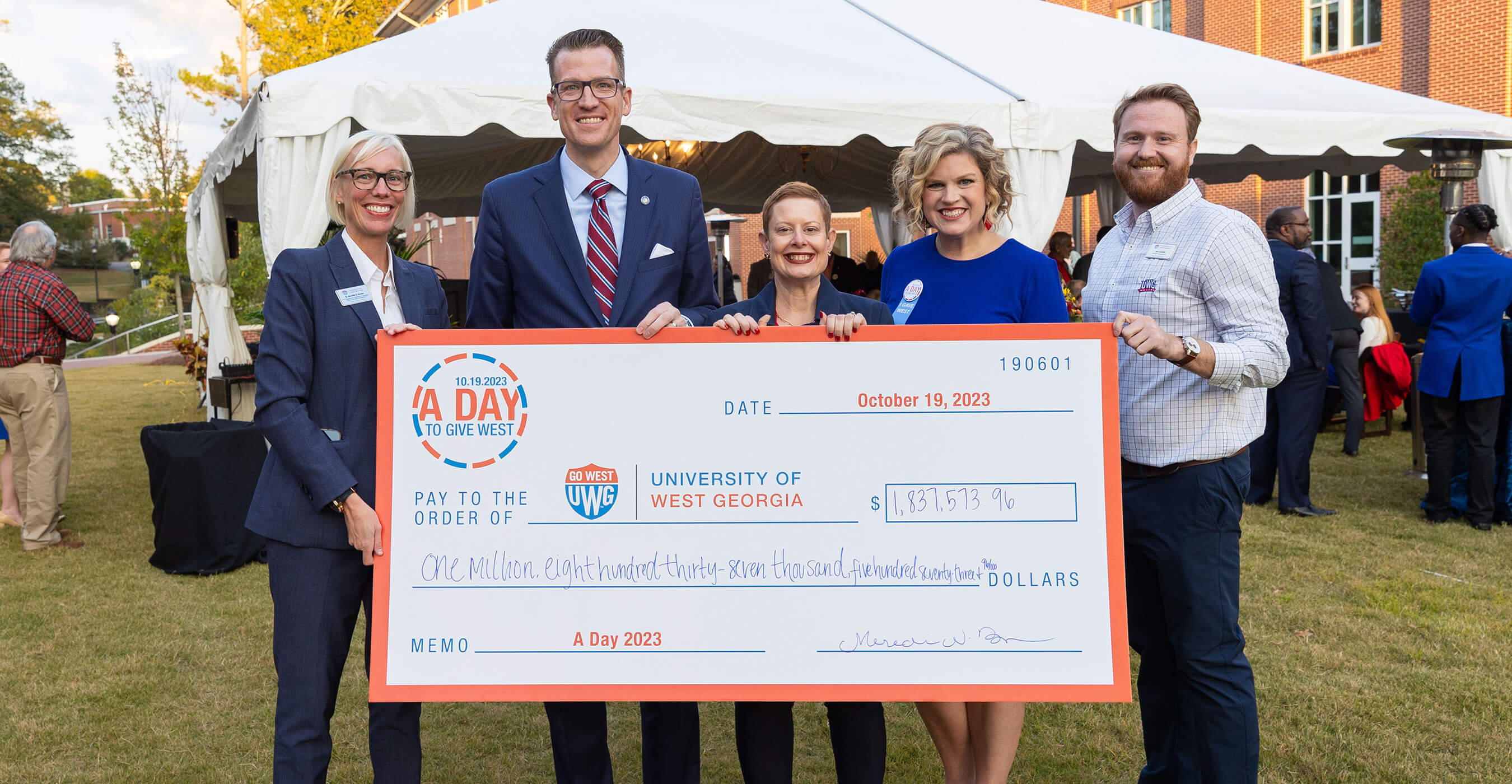 UWG administration holding a giant check for A Day