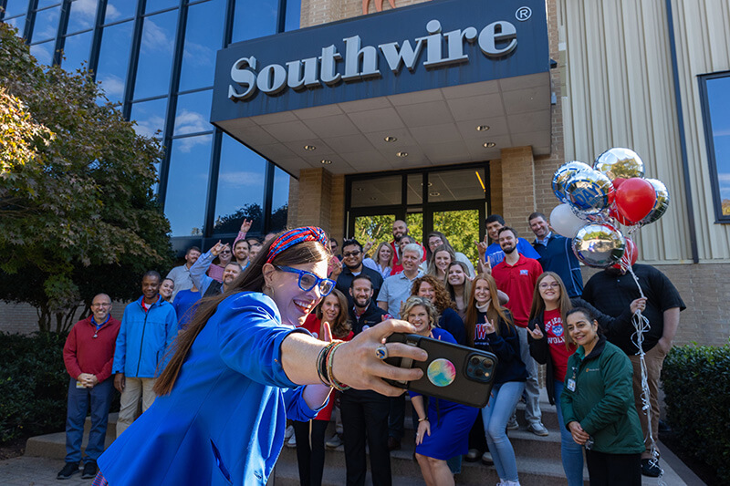 People taking pictures of celebrating UWG's A Day at Southwire