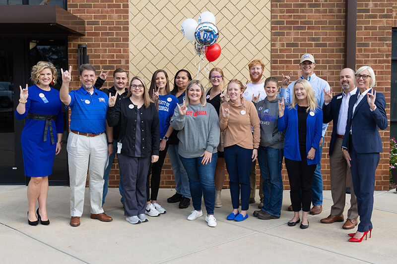 UWG leaders passing out A Day balloons