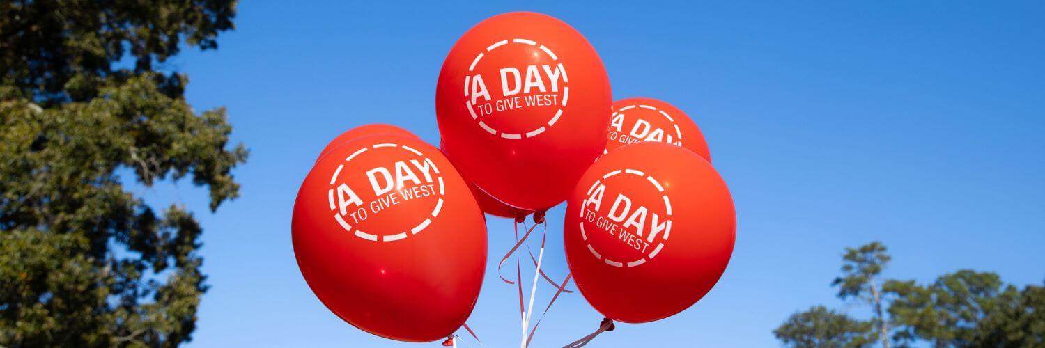 Red UWG balloons that say A Day