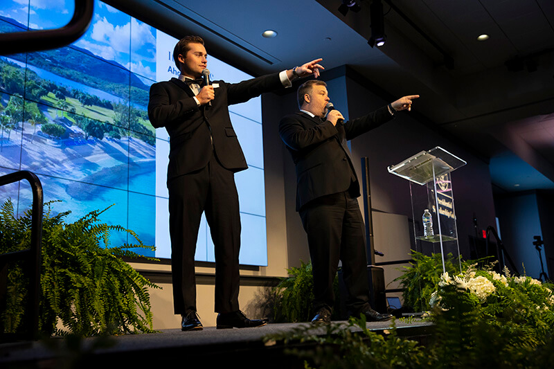 Auctioneers point to the crowd at the UWG Presidential Gala