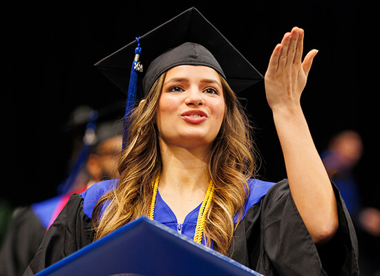 A graduate celebrates at UWG commencement