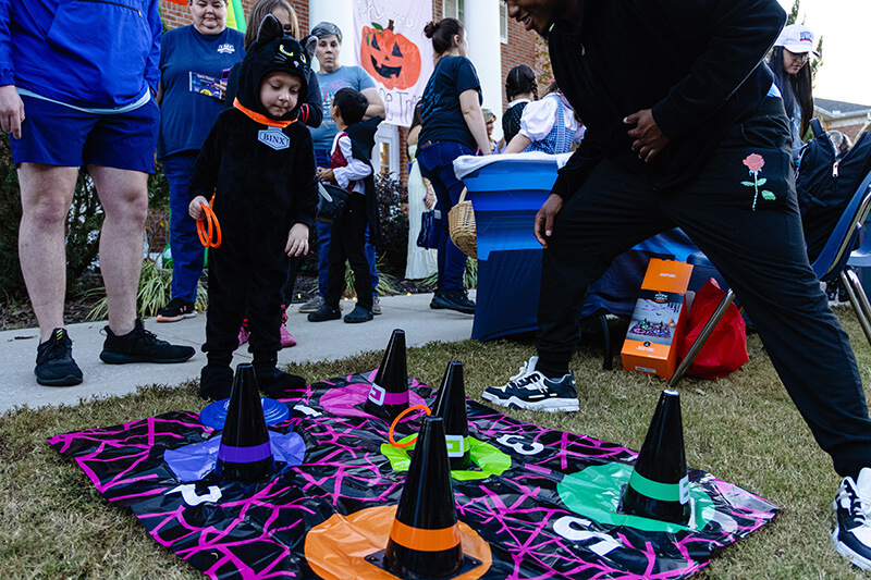 Child in costume plays a Halloween game at UWG's Safe Treat