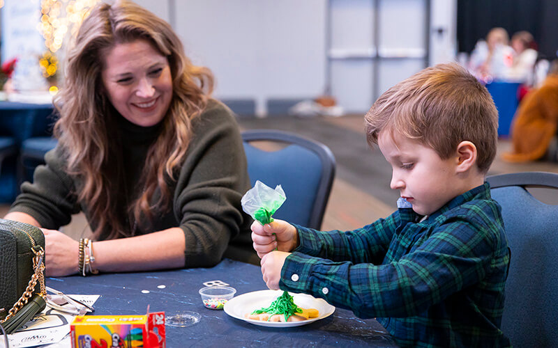 A child decorating holiday cookies