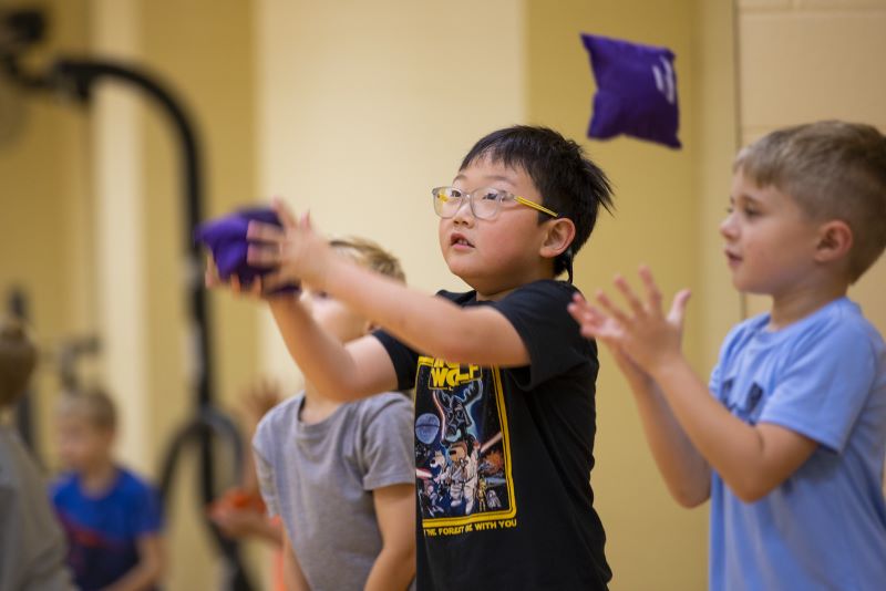 A child in glasses enjoys a UWG summer camp