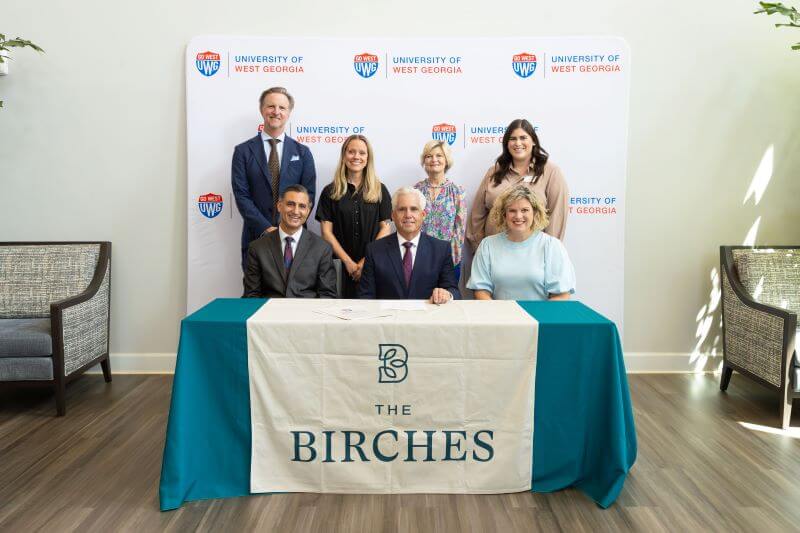 The signing of the partnership between The Birches on Maple and the University of West Georgia.