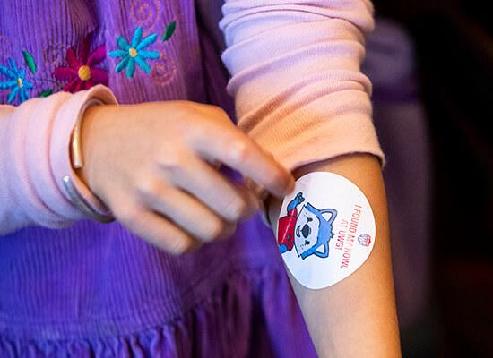 Arm with sticker that reads "I found my howl at UWG".