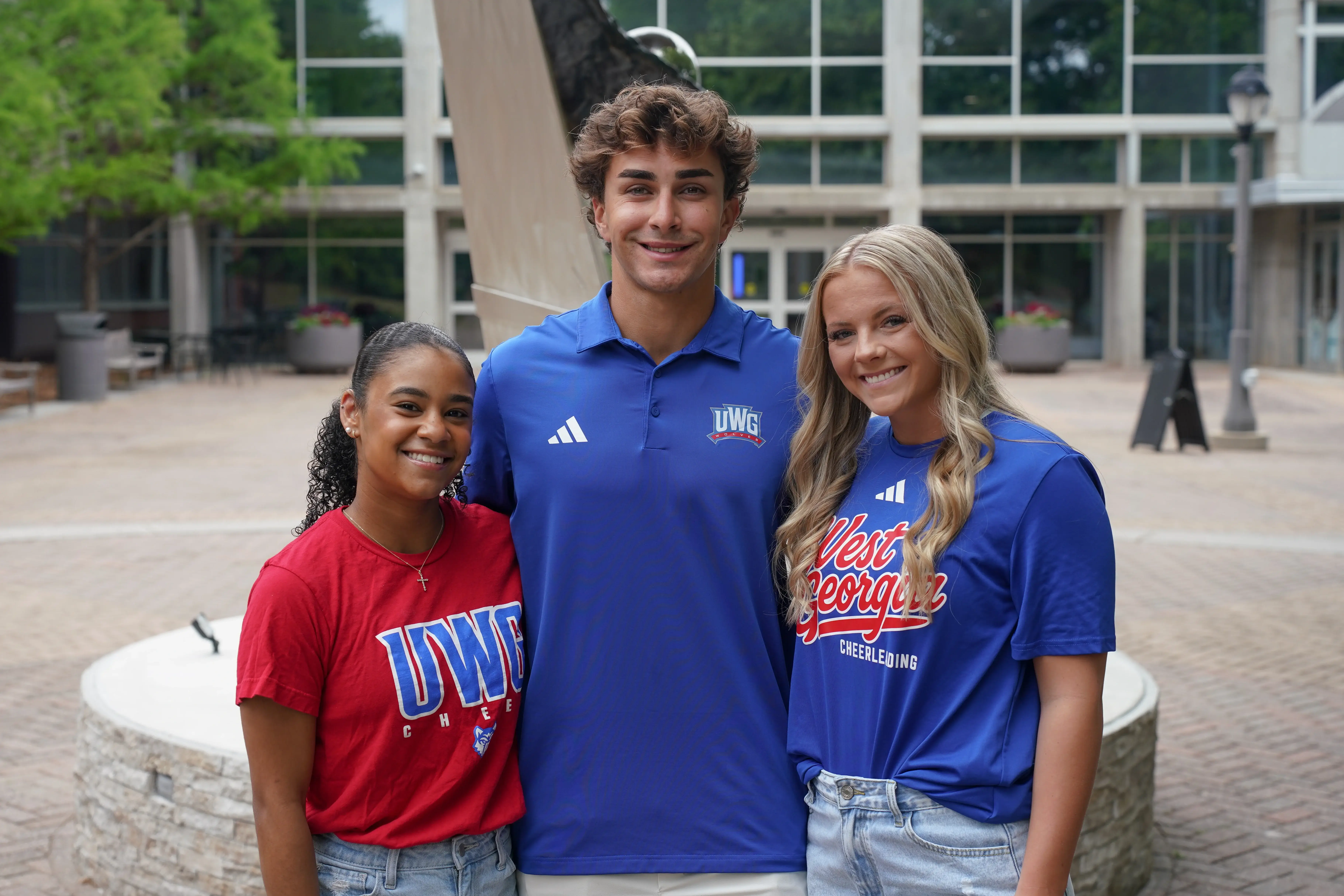 Three smiling UWG students outside on campus
