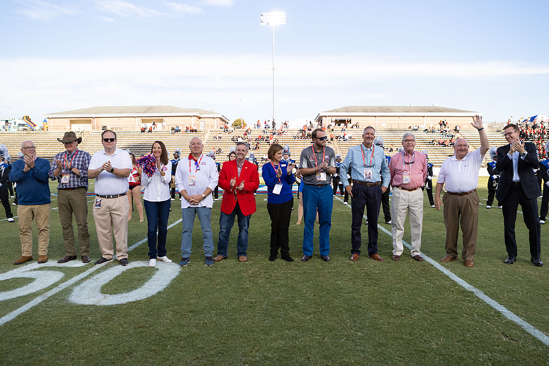 A group of dignitaries on the UWG football field