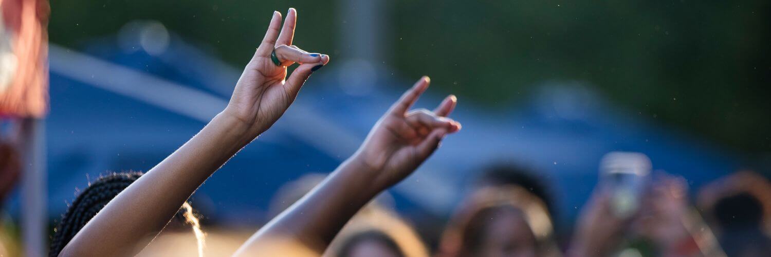 UWG students giving the Wolves Up hand sign