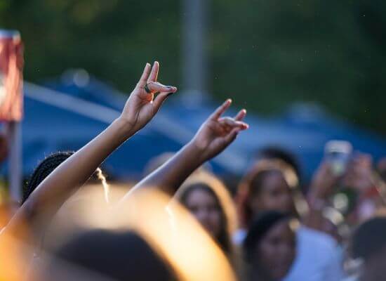 UWG fans giving the Wolves Up hand sign