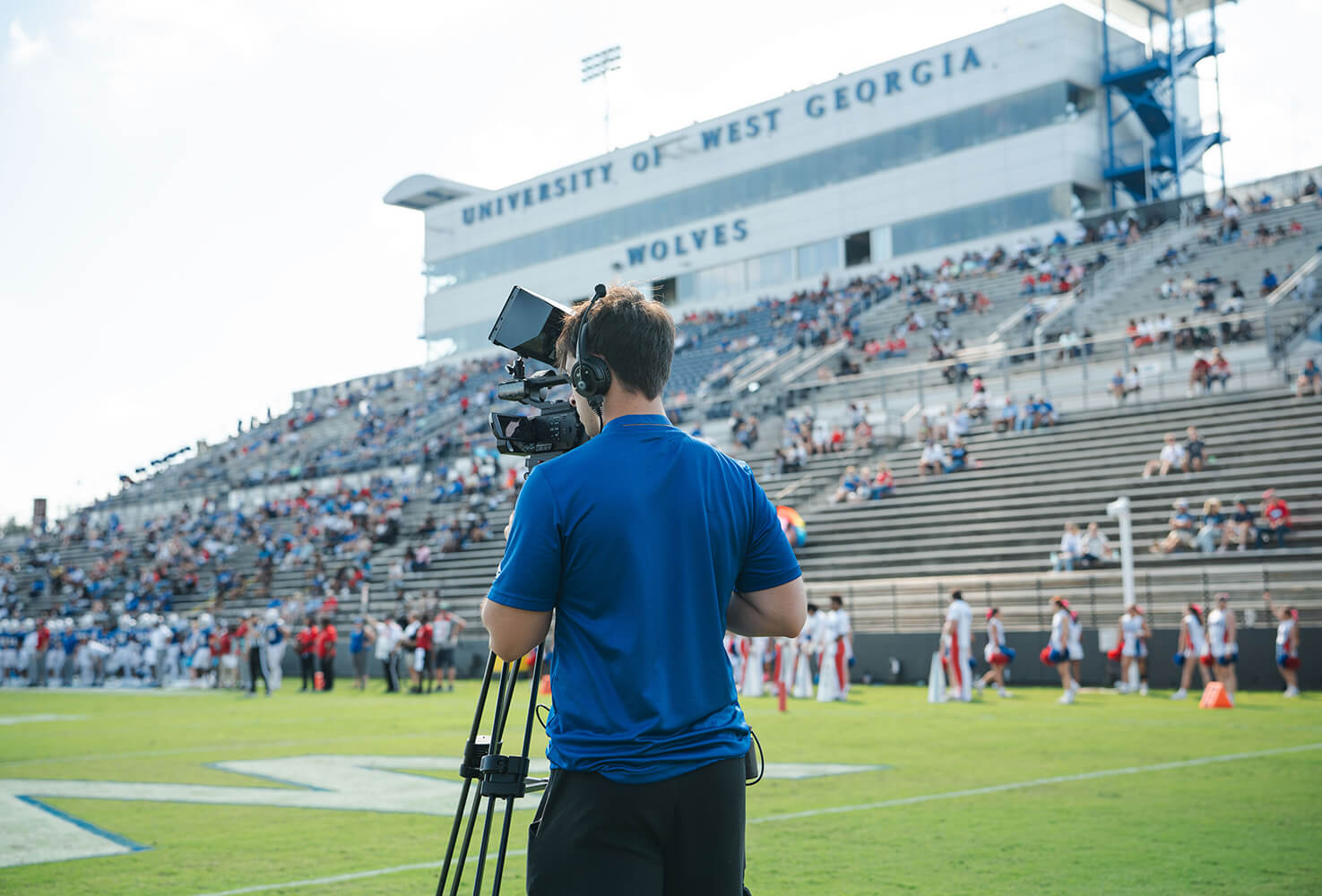 UWG Productions student filming at a Wolves football game