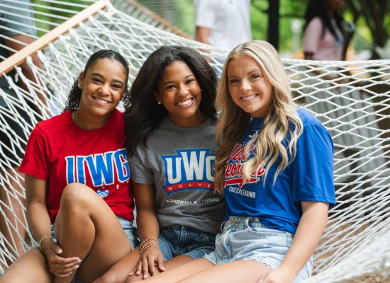Three UWG students outside in a hammock