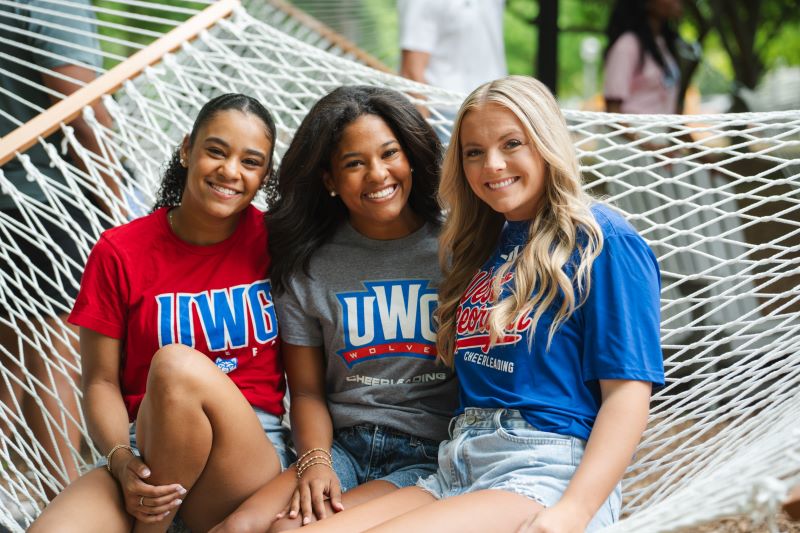 Three UWG students outside in a hammock
