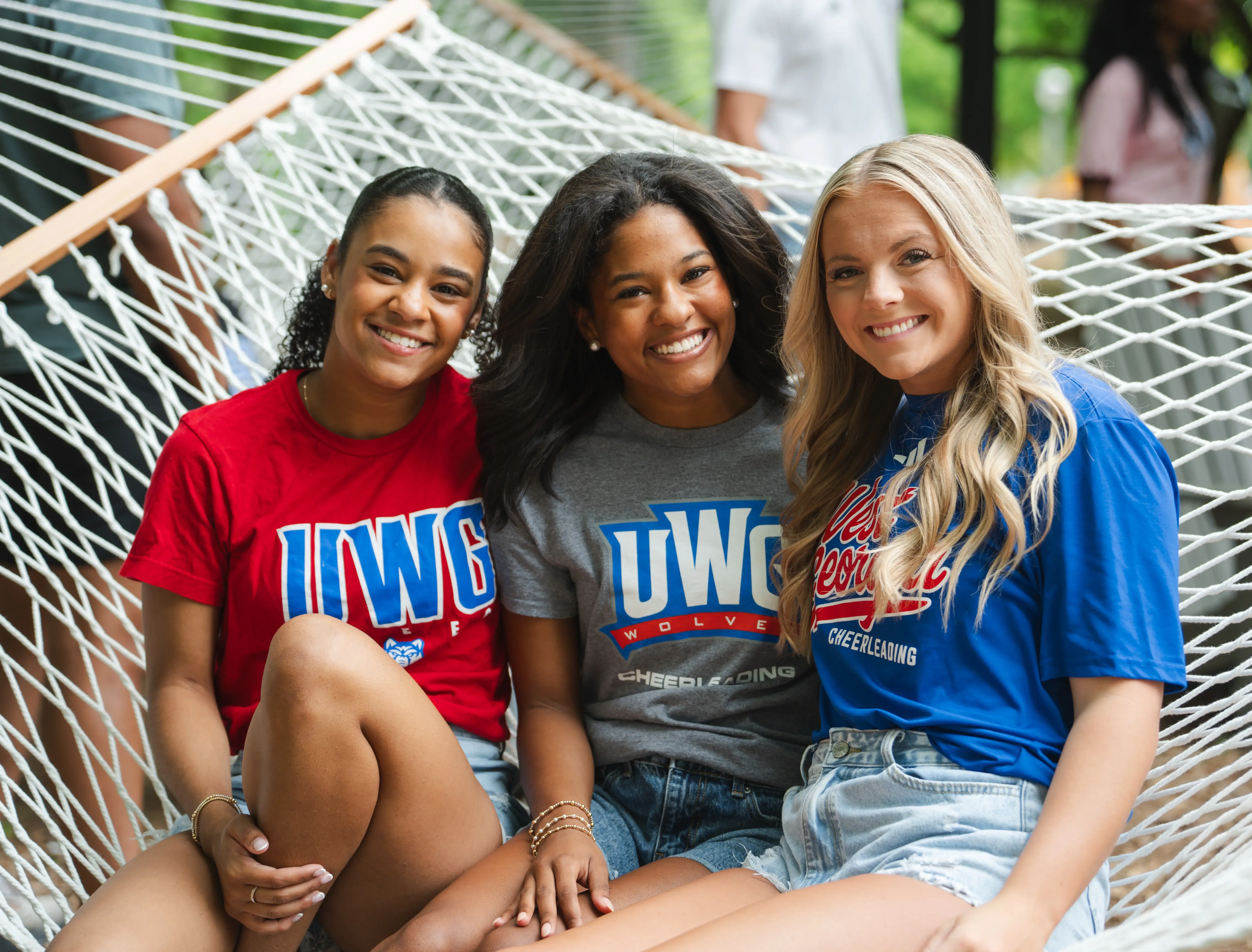 Three UWG students outside in a hammock