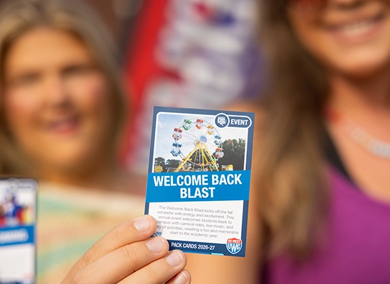 A UWG student holds up a Pack Card