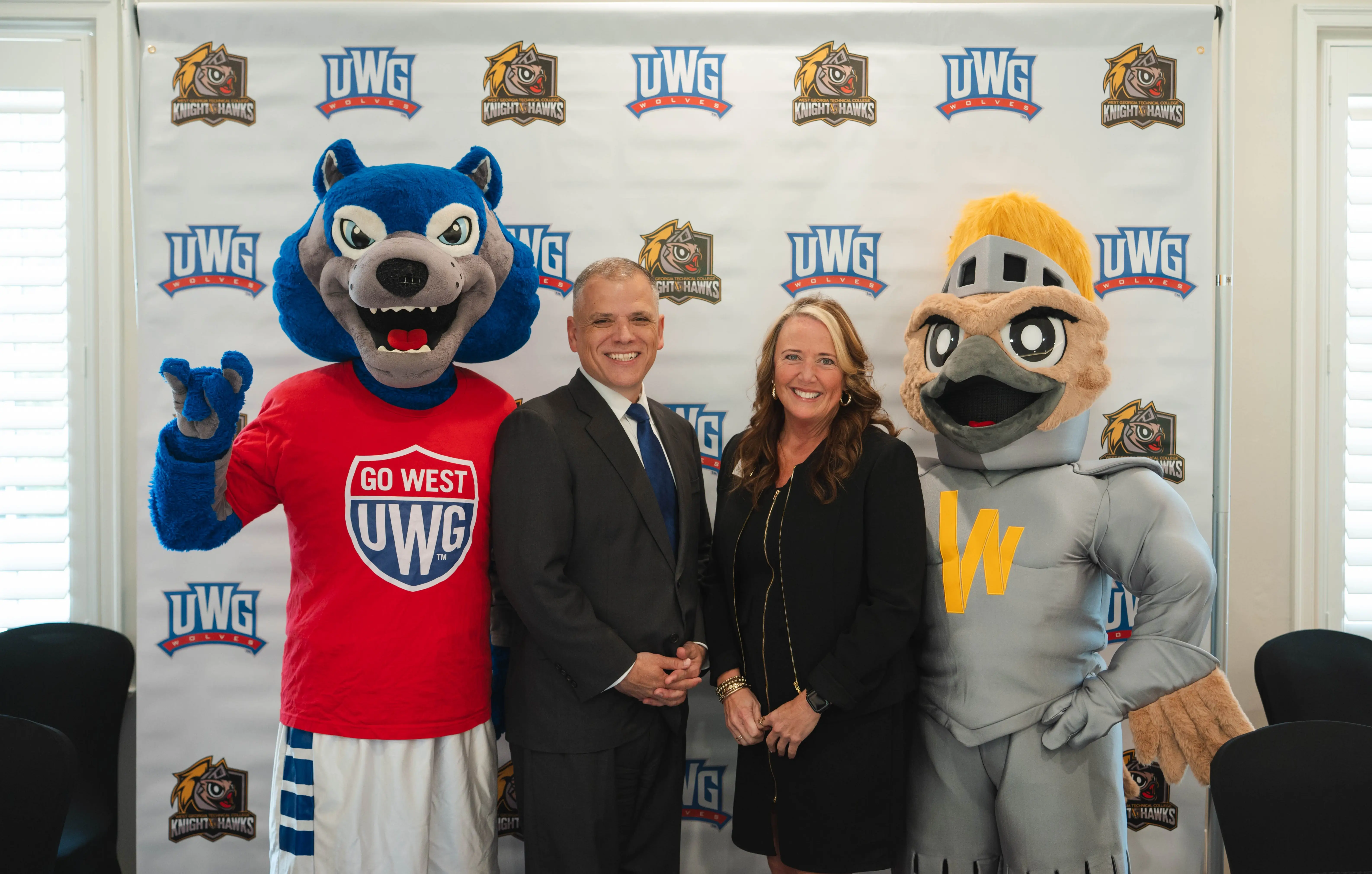 Drs. Michael Johnson (UWG) and Julie Post (WGTC) with their school's mascots