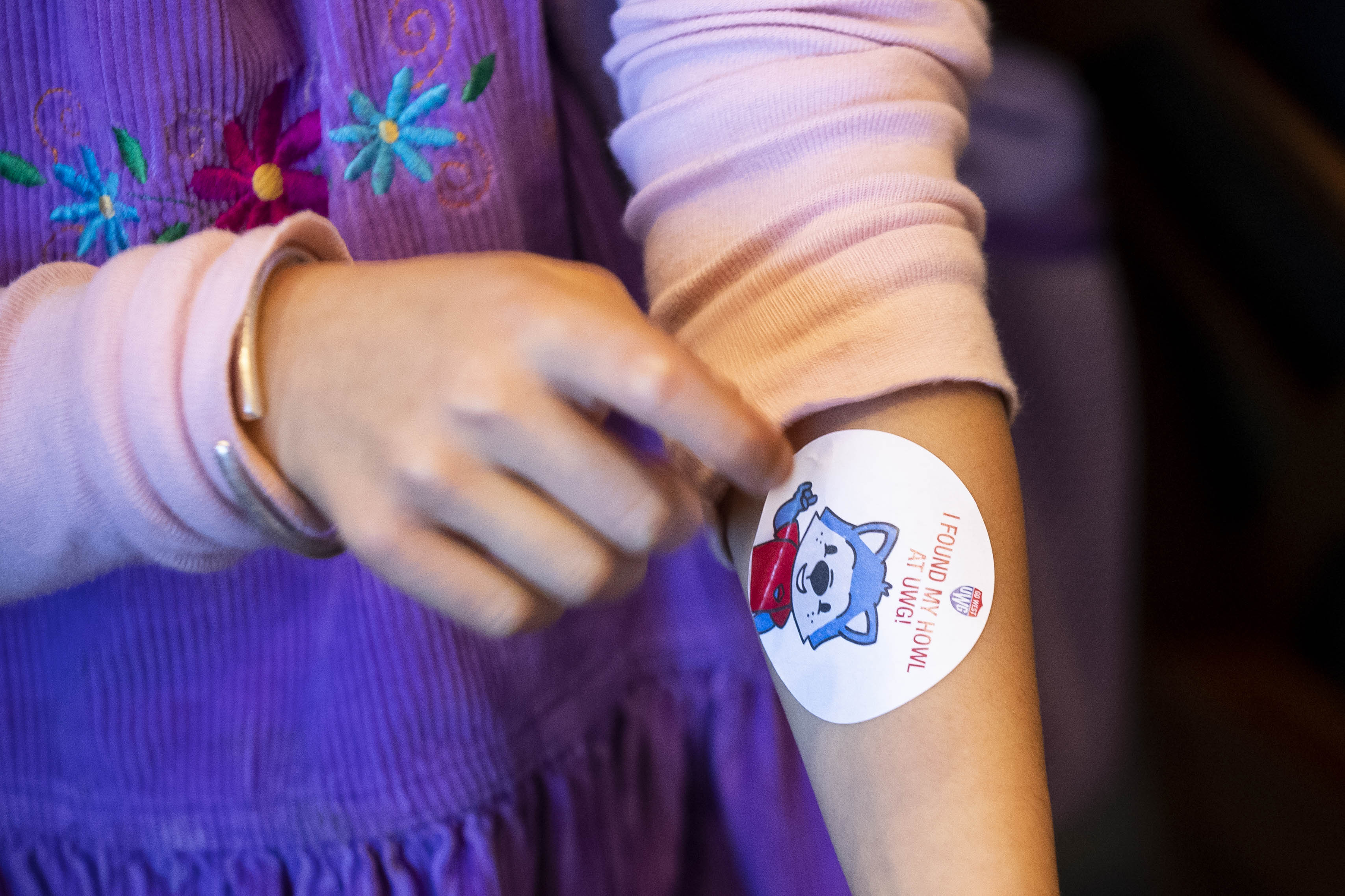 child with woflie sticker on her arm