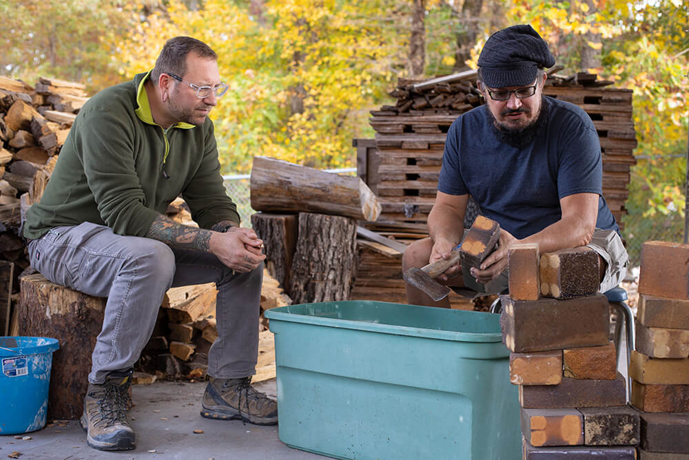 Art faculty Nathan Carnes and David Collins at the anagama kiln site