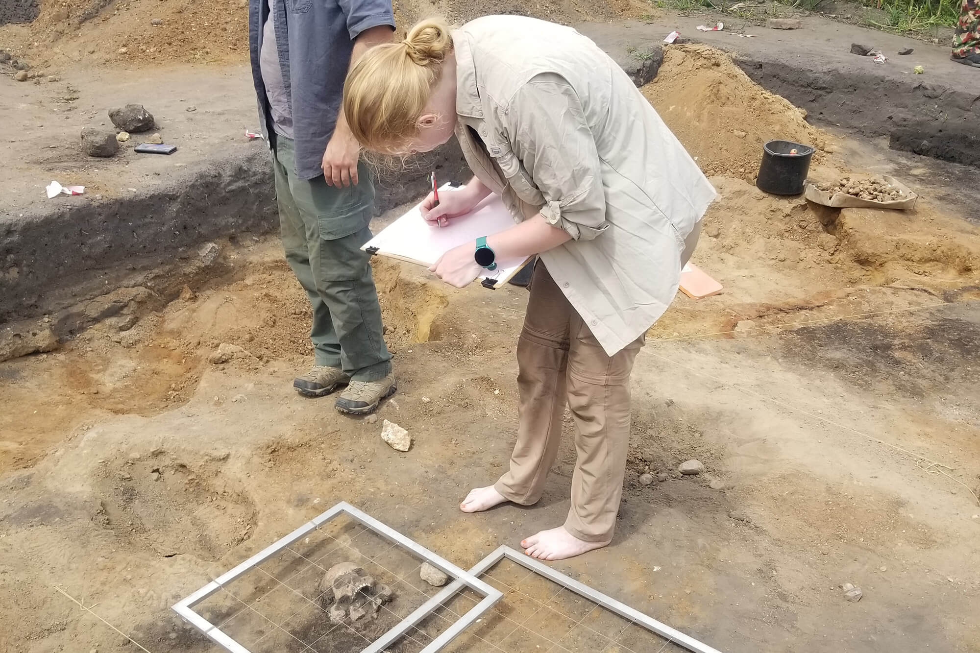 Rogers and another student mapping a grave in Giecz, Poland.
