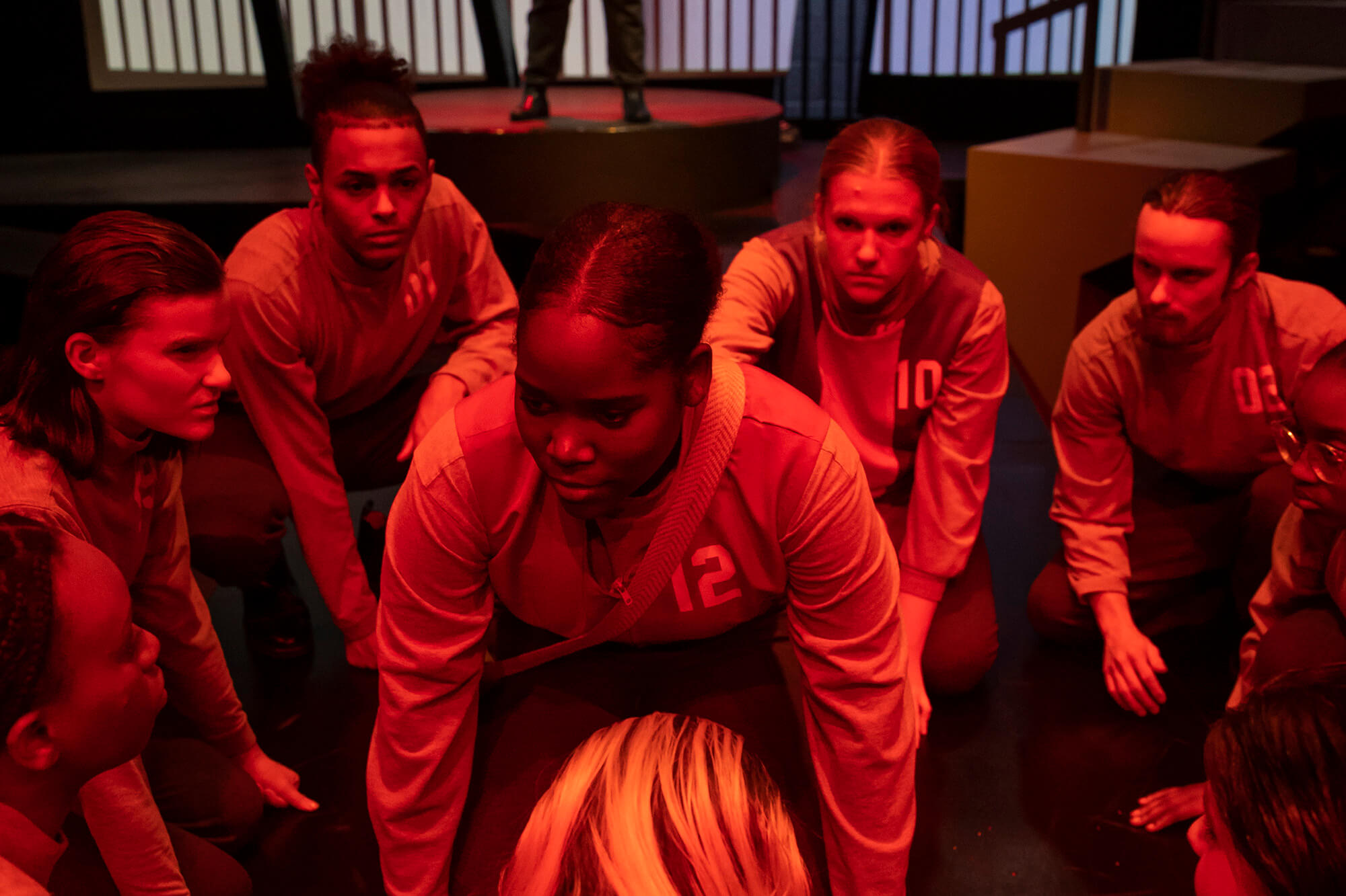 UWG theatre students under red lighting