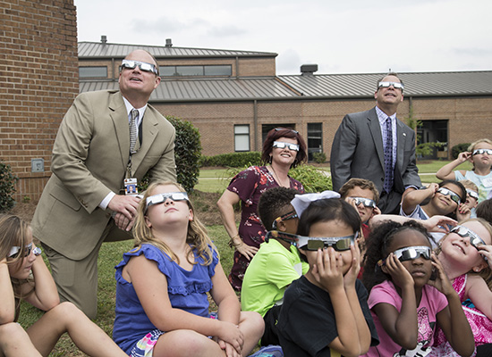 People look up to the sky while waiting for eclipse