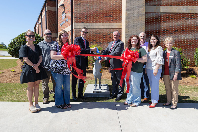 From left to right: Brandy Barker, UWG faculty and executive director for creative services; Ryan Lamfers, UWG senior lecturer of art: sculpture and foundations;  Vanessa Benefield, student; Dr. Brendan Kelly, UWG president; Scott Cowart, Carroll County Schools superintendent; Brianna Henry, student; Bryant Turner, Board of Education chairman; Charity Aaron, CCS director of partnerships and communication; and Lawana Knight, BOE member.