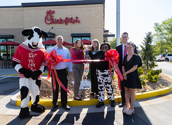 Members of the UWG and Chick-fil-A communities cut the ribbon on a wolf statue