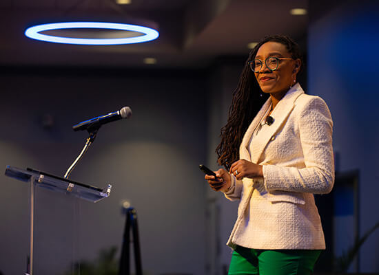 Tramaine EL-Amin speaking to a large audience at UWG's annual Women Empowering Women event